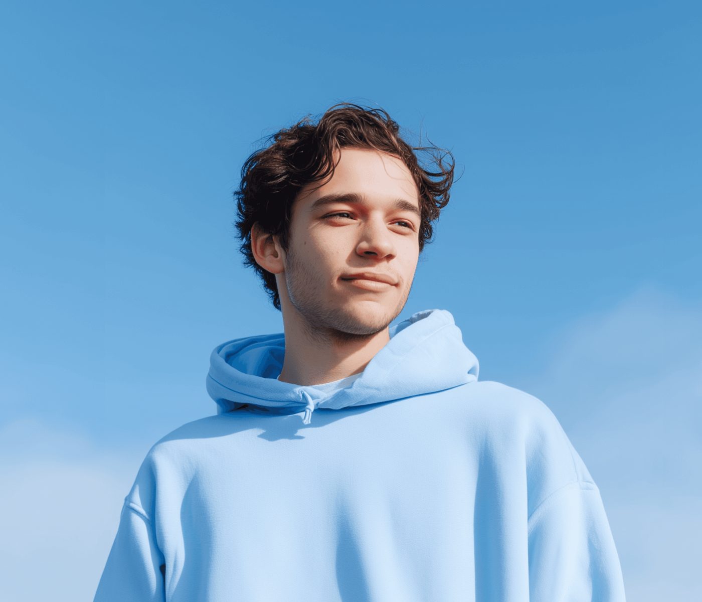 A young store owner looking up at a clear sky